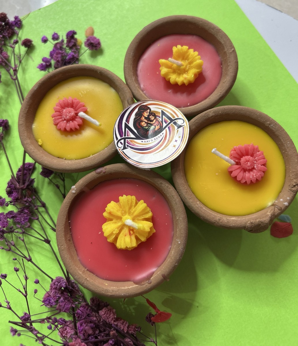 Red and yellow clay diya candles in a pack of four
