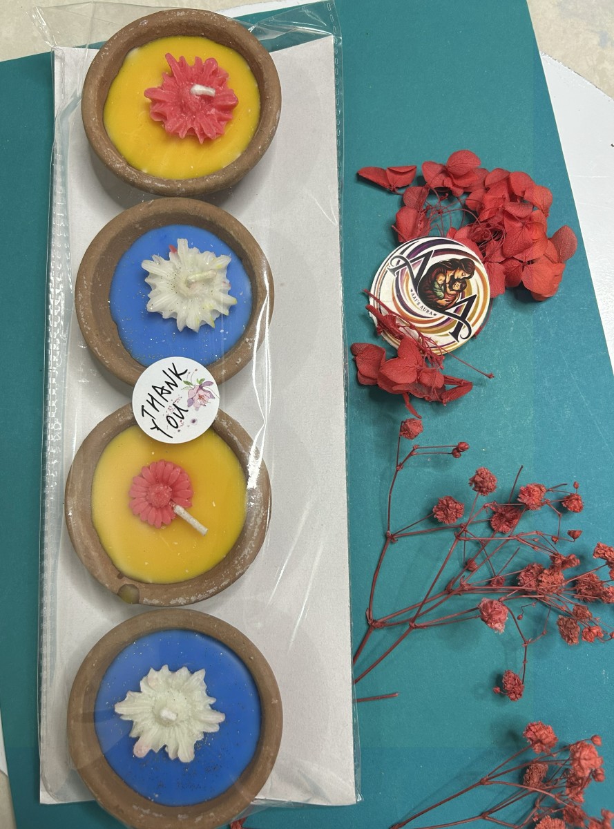 Yellow and blue clay diya candles in a pack of four