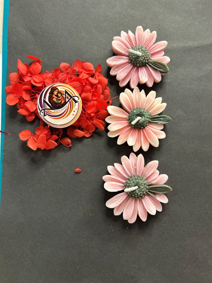 Pink daisy candles with green centres