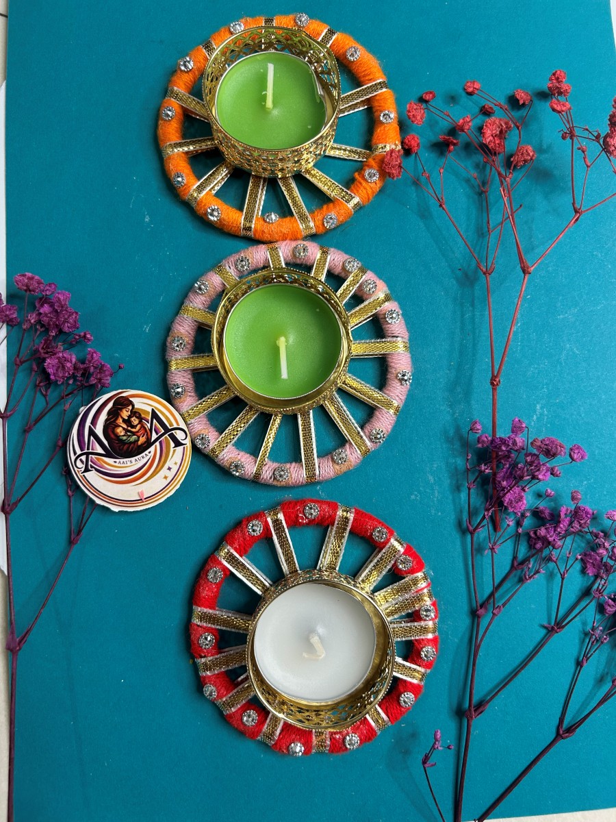 Decorative diyas including a red thread diya with a white centre