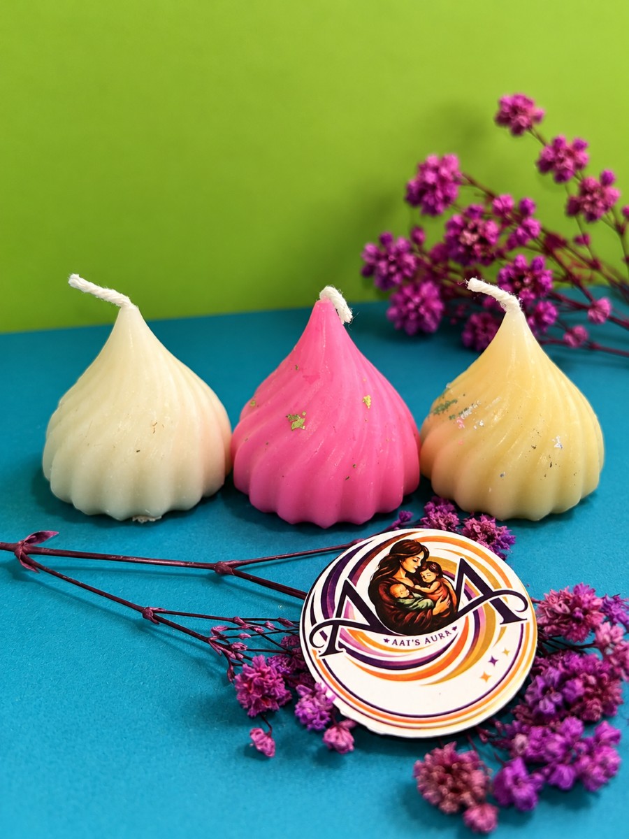Cream, pink, and pale yellow modak candles together