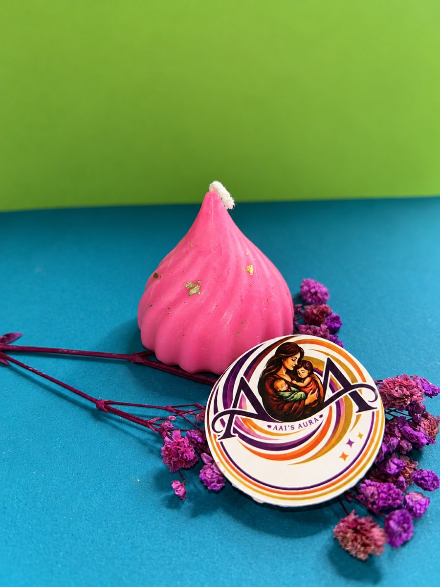 A pink modak-shaped candle