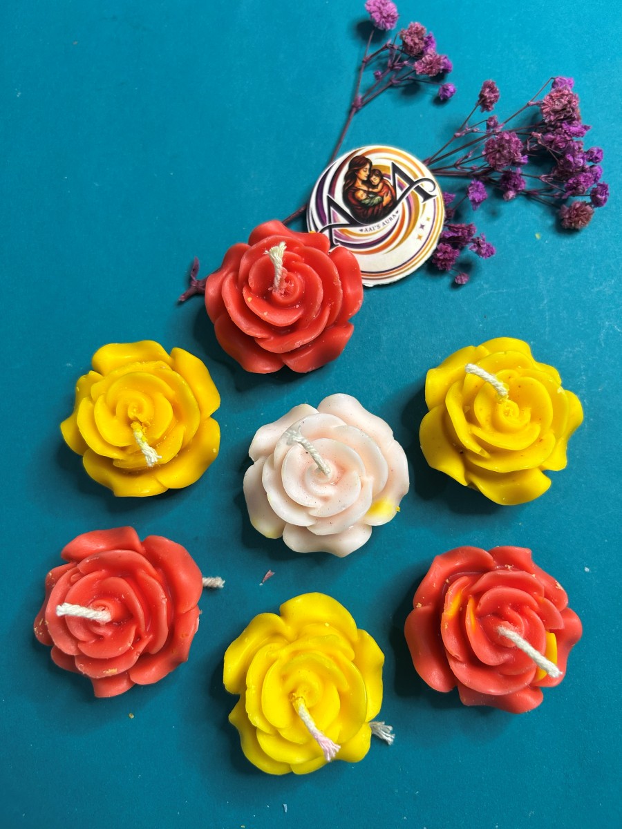 Yellow rose candles among red and pale pink roses