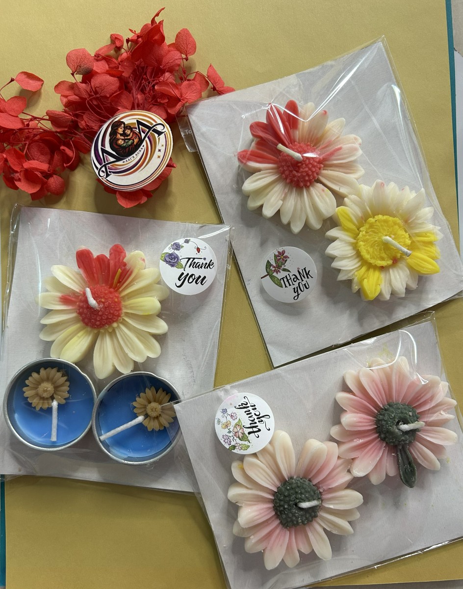 Two tea lights with a daisy candle arranged for gifting
