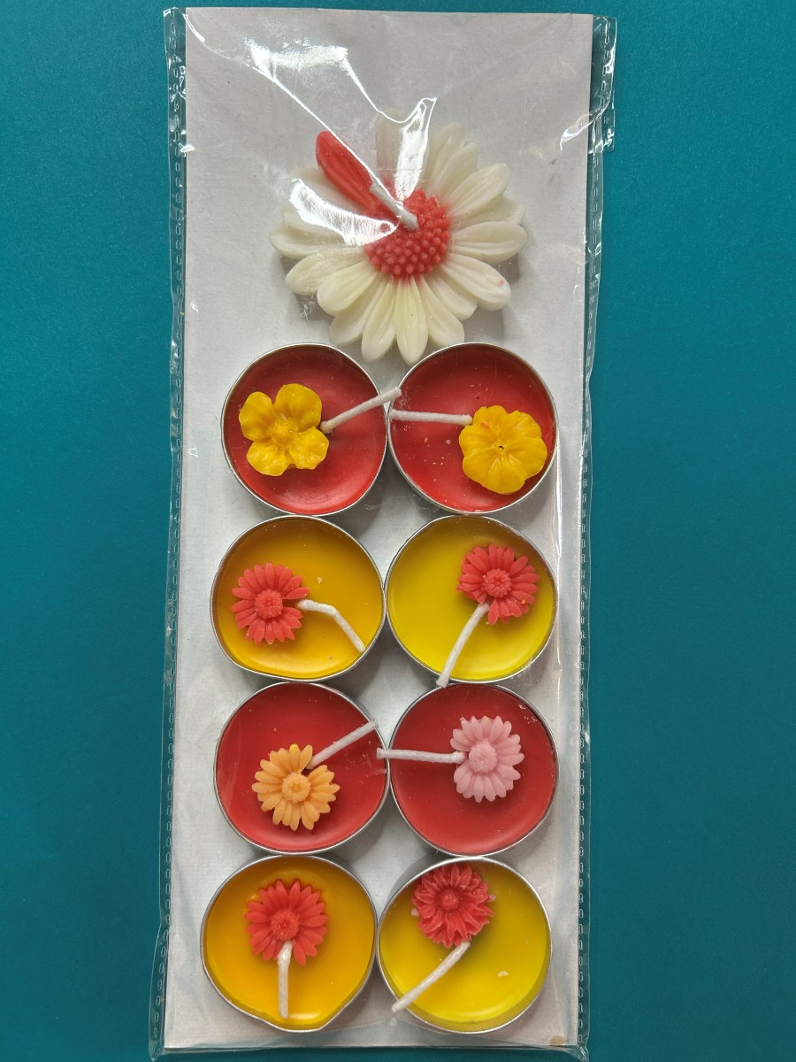 Eight red and yellow floral tea lights with one daisy candle