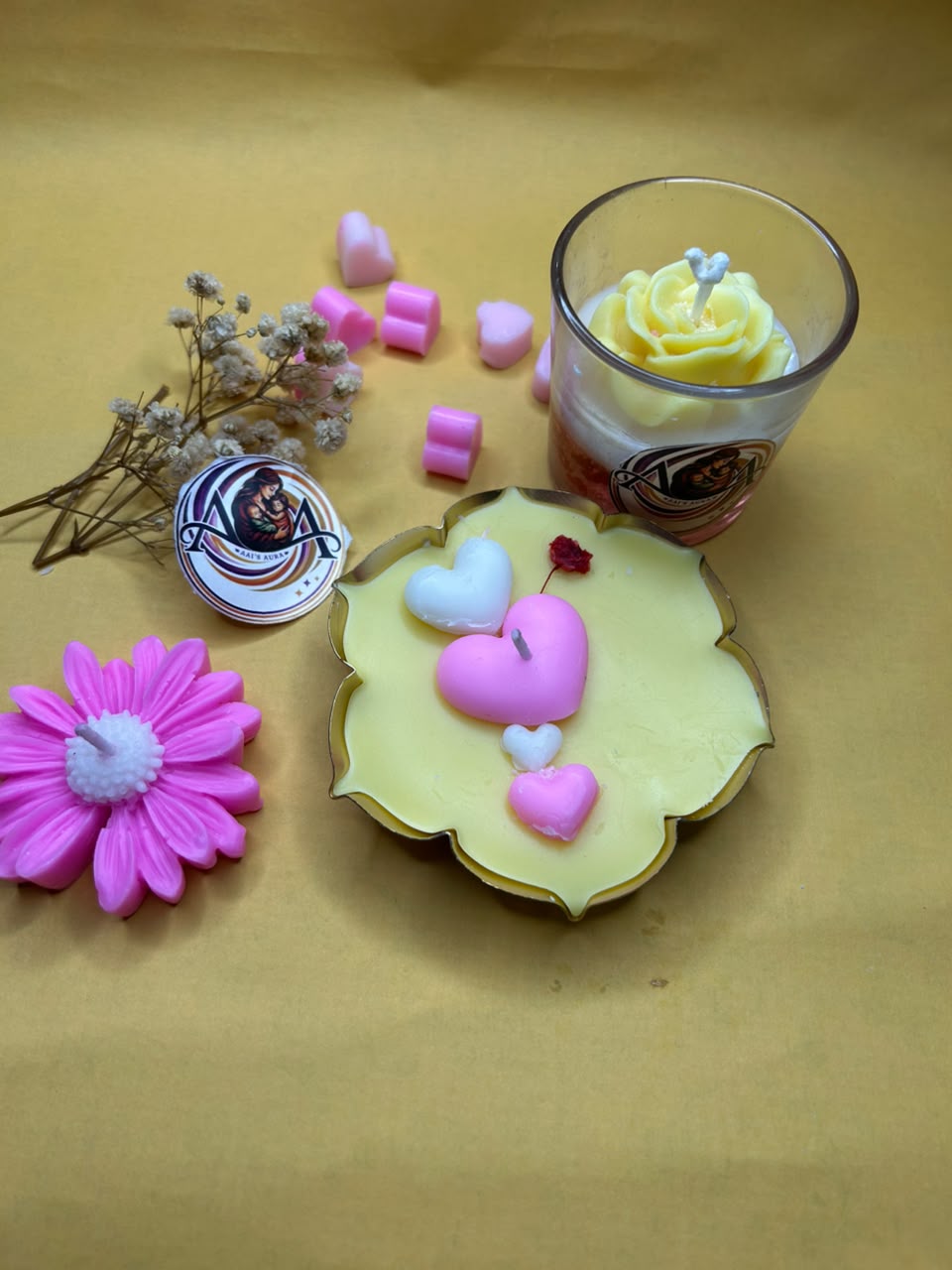 One urli, one glass candle, and one pink daisy