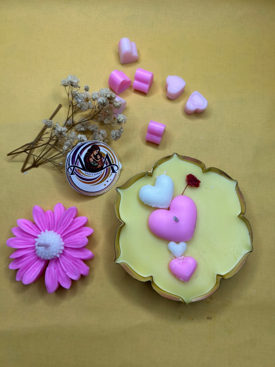 One urli and one pink daisy candle